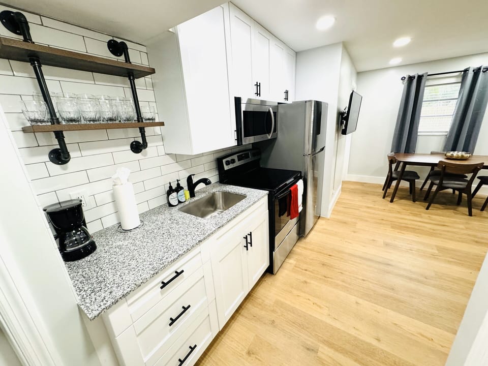 Welcome to your modern kitchen with sleek countertops, modern appliances, and ample storage. Natural light enhances the warm ambiance, creating a versatile and inviting space for all your culinary endeavors.