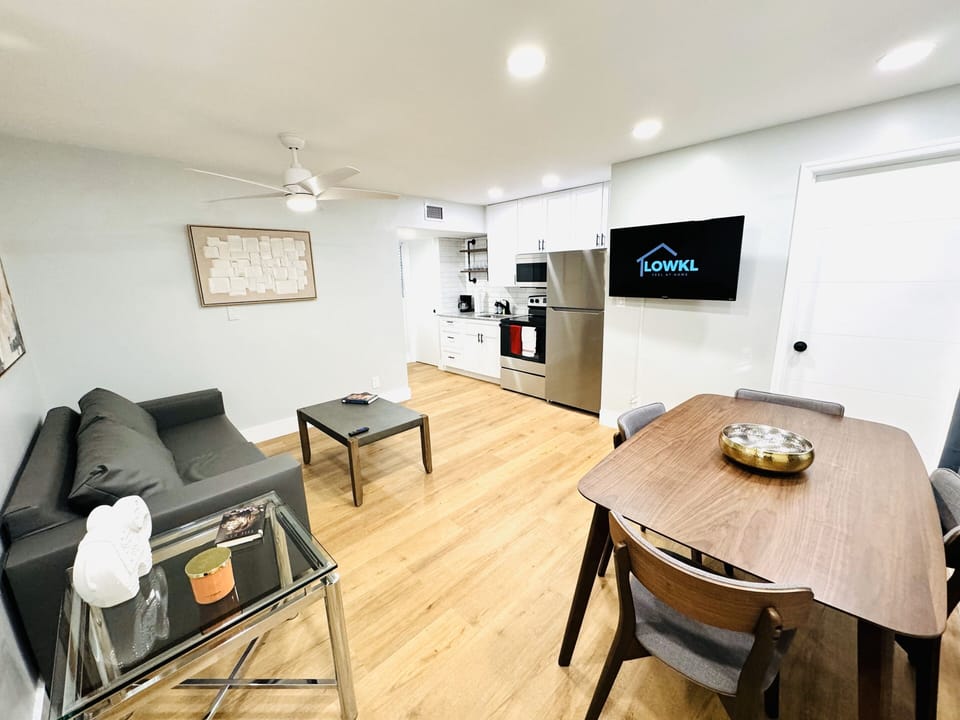 Our sofa area with this cozy dining table designed for four, where shared meals turn into cherished moments. The simple yet stylish setup invites connection, adorned with comfortable seating and a tabletop ready for laughter and conversations