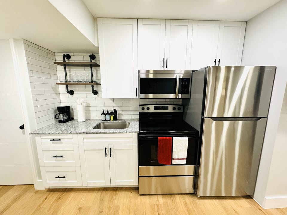 Welcome to your modern kitchen with sleek countertops, modern appliances, and ample storage. Natural light enhances the warm ambiance, creating a versatile and inviting space for all your culinary endeavors.