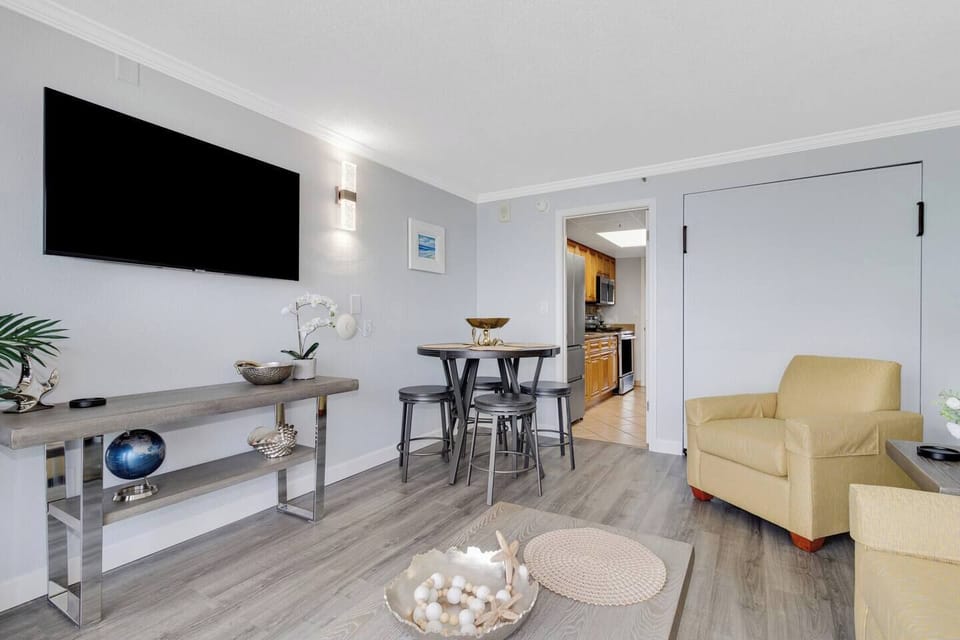 The living room offers versatile sleeping options with a convertible sofa bed, a Murphy bed, and an additional floor mattress for your convenience.