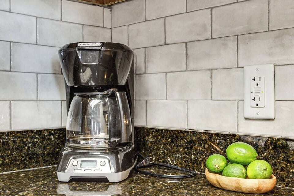 Curate a streamlined coffee station on the kitchen counter, featuring a sleek coffee maker that promises both functionality and style.
