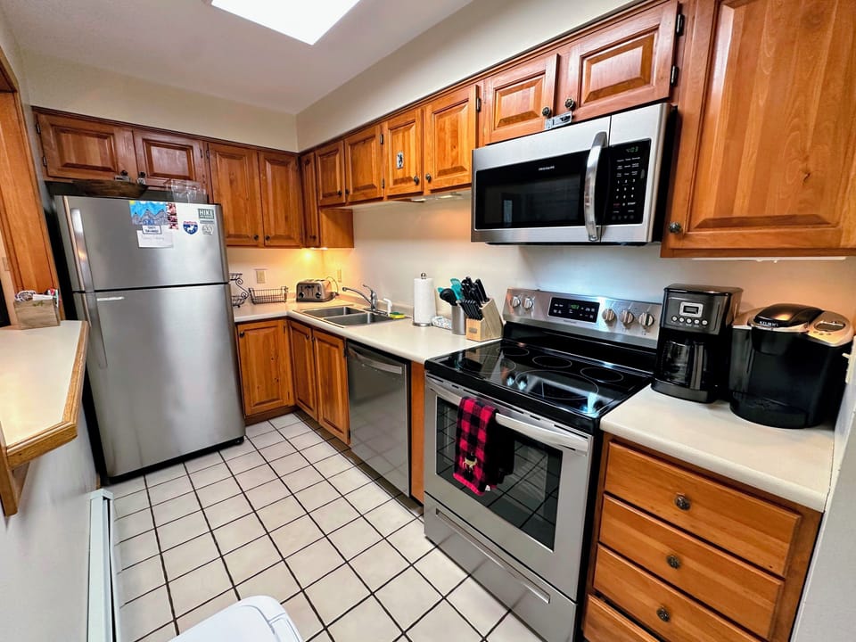 Galley kitchen with pass-through window to living area