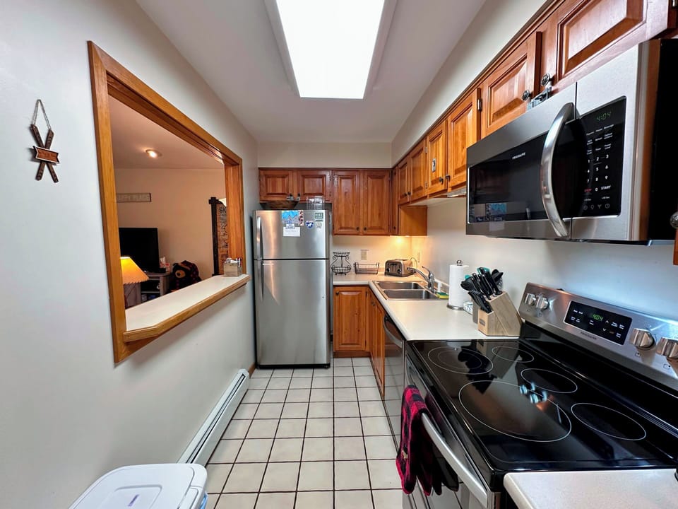 Galley kitchen with pass-through window to living area