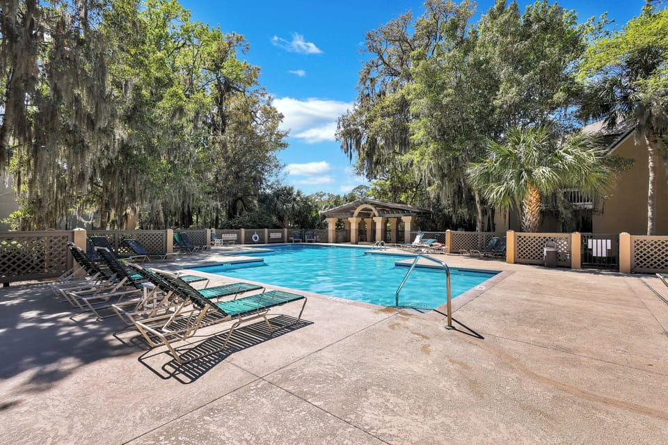 Relax and unwind beneath the moss-draped oaks at this community outdoor pool oasis, perfect for soaking up the sun or enjoying a refreshing swim
