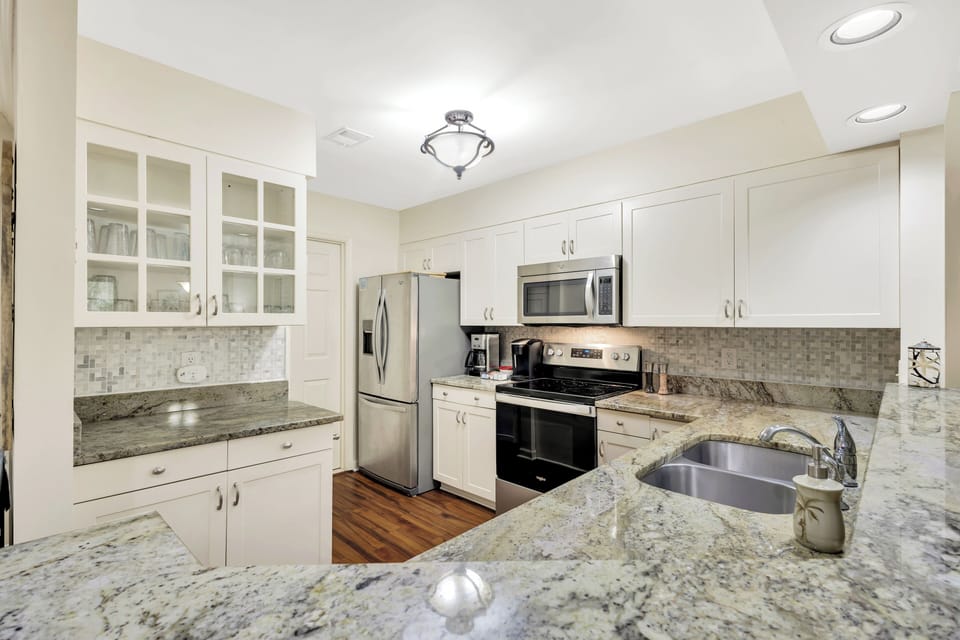 To your left from the entrance, a large, fully-equipped kitchen awaits, simplifying meal preparation.