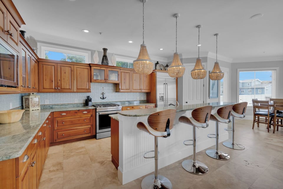 Here, the open-concept design seamlessly connects it with the kitchen, dining area, and outdoor pool deck, making it an ideal entertaining hub.