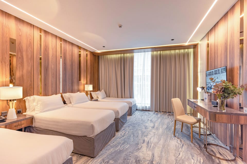 Junior Quadruple Room, 1 Bedroom, City View | In-room safe, blackout drapes, soundproofing, iron/ironing board
