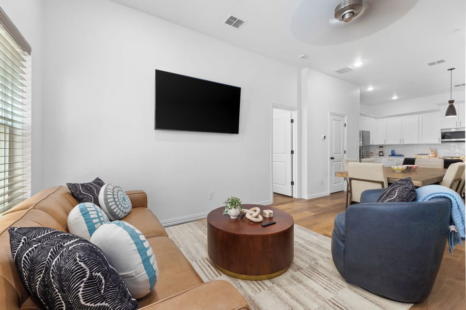 Kick back in a stylish, open-concept living space designed for comfort and connection. Whether you're debriefing after a Rangers game, watching pre-game coverage on the smart TV or just relaxing with your crew—The Ryan's living area has you covered.