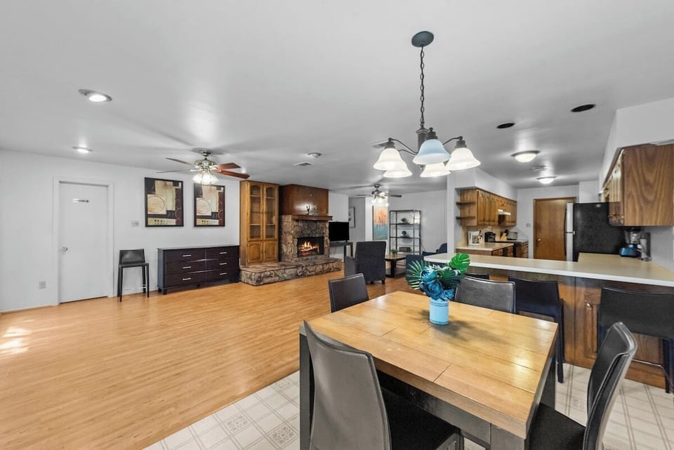 The dining table comfortably seats four and is situated next to the kitchen, making it easy to serve and enjoy meals.