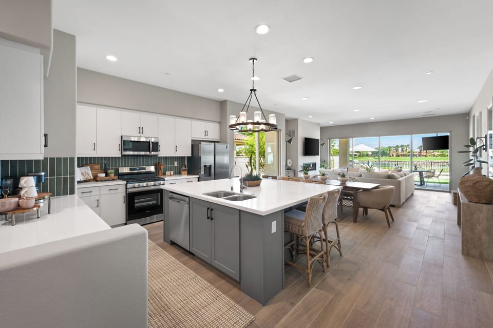 Modern kitchen with large island, lake views, and everything you need to cook.