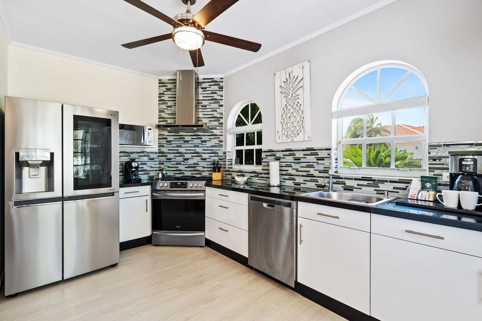 Cook up a storm in a fully equipped kitchen, perfect for gourmet meals and family feasts - Discover the joy of home-cooked meals in a kitchen with stainless steel appliances - Featuring sleek countertops and plenty of storage