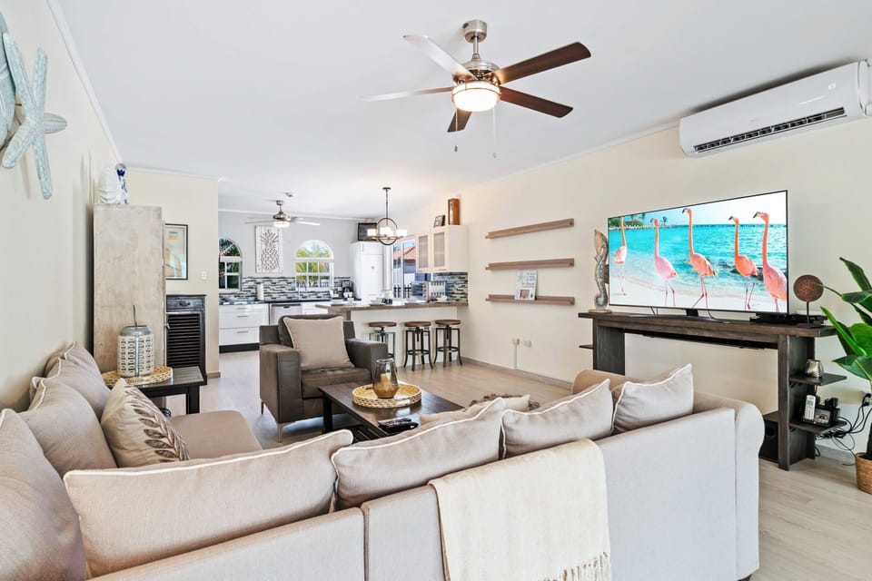 Enjoy cozy evenings in a beautifully decorated living space with plenty of natural light - Provides a comfortable setting for conversations and a smart TV for entertainment - Experience the charm of open design for seamless access