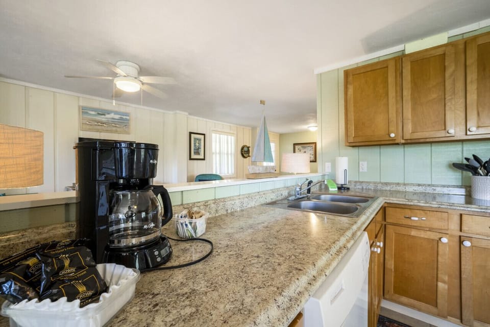The kitchen has a 12 cup drip coffee maker and coffee