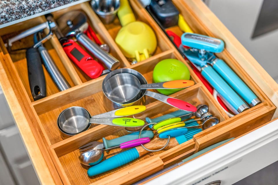 fully equipped kitchen with utensils, measuring cups and pots / pans 