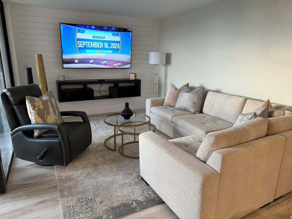 Large comfy living room with sectional and recliner. 
Smart TV.