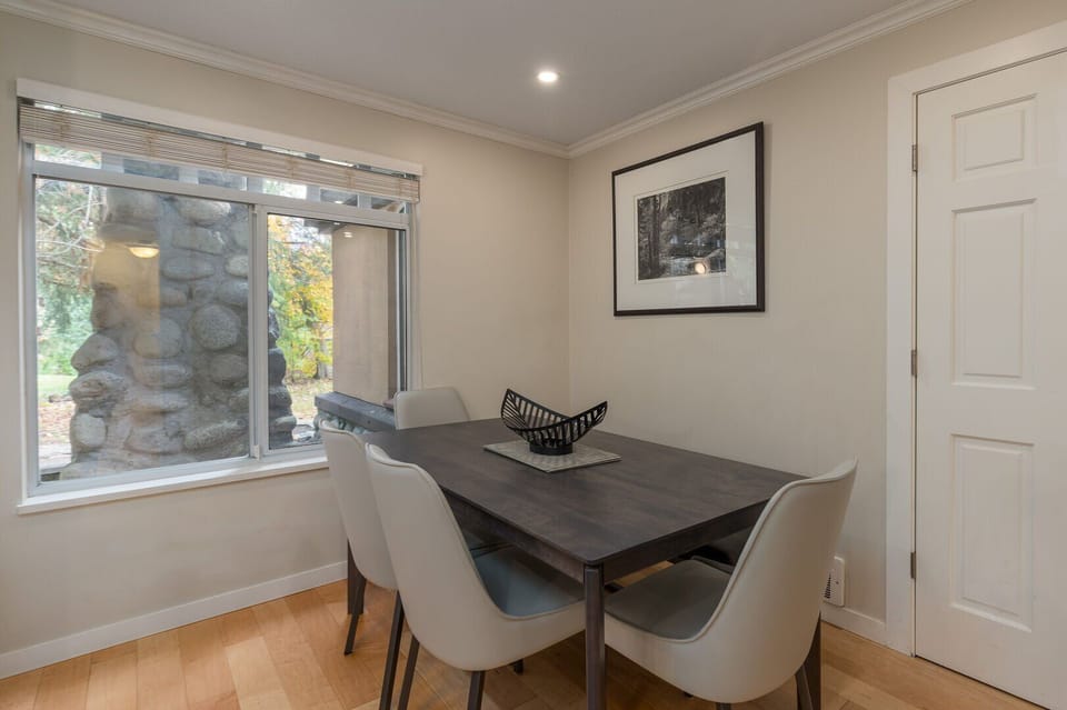 Share a meal at the cozy dining table, comfortably seating four guests.