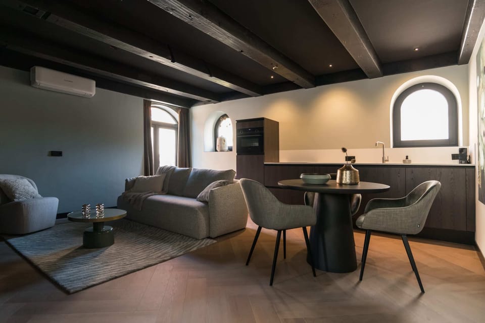 Alternate view of living room space, with dining table and windows