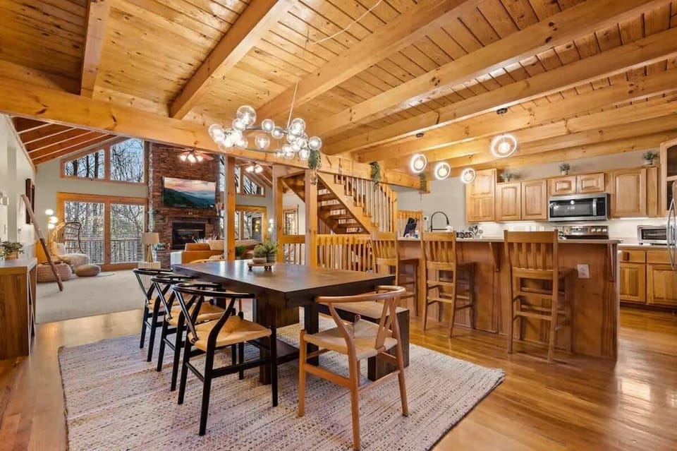 Gather around the stylish table under stunning beams for unforgettable meals!