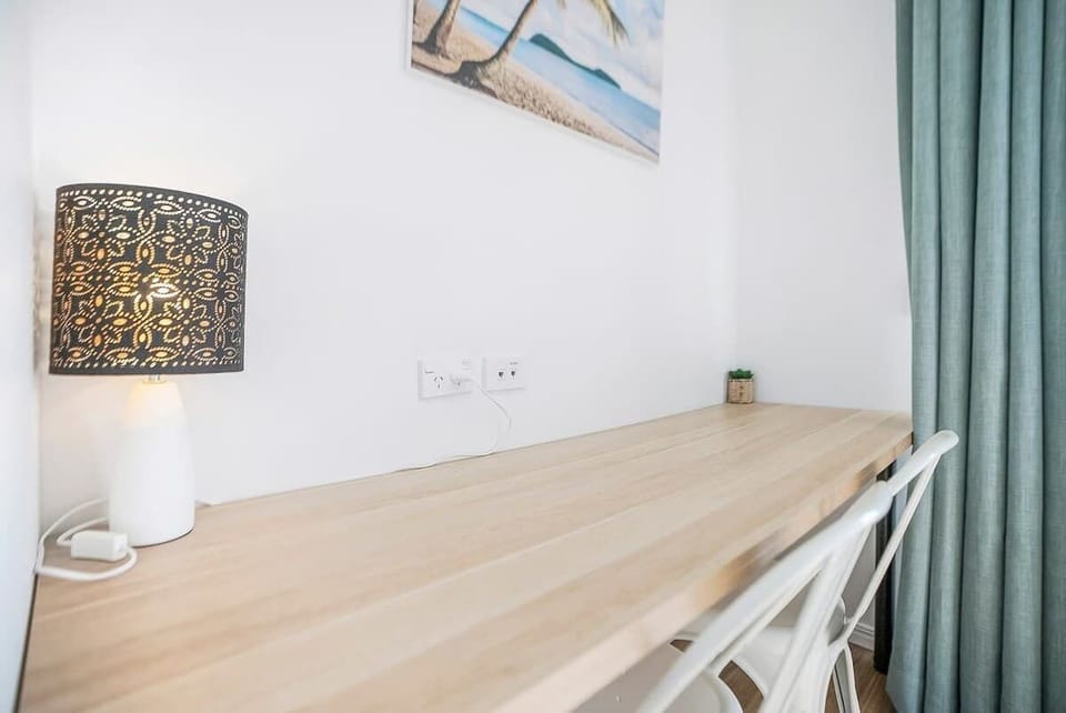 A desk and chair cater to those on a working holiday needing to set up their laptop.