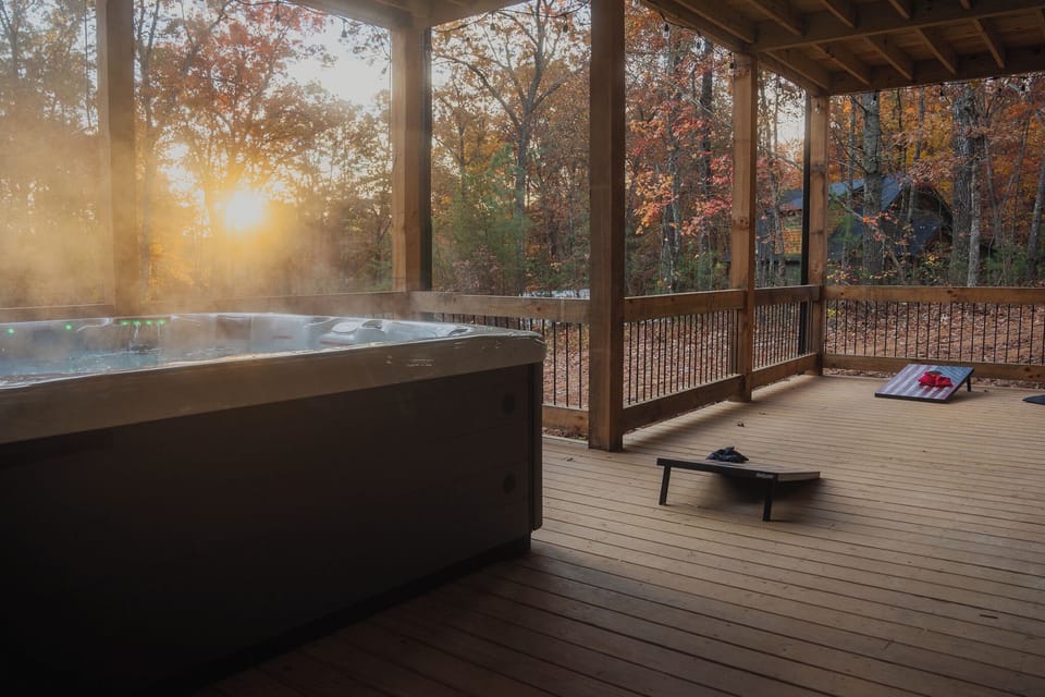 Sink into comfort—private hot tub, cornhole & forest views on secluded porch.