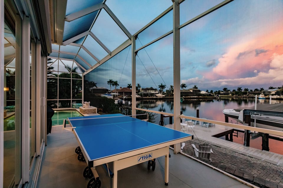 Outdoor Game Area: Play ping pong with stunning waterfront views at sunset! Fun awaits!