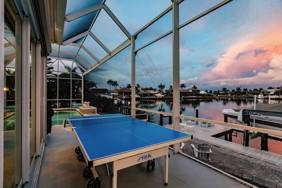 Outdoor Game Area: Play ping pong with stunning waterfront views at sunset! Fun awaits!