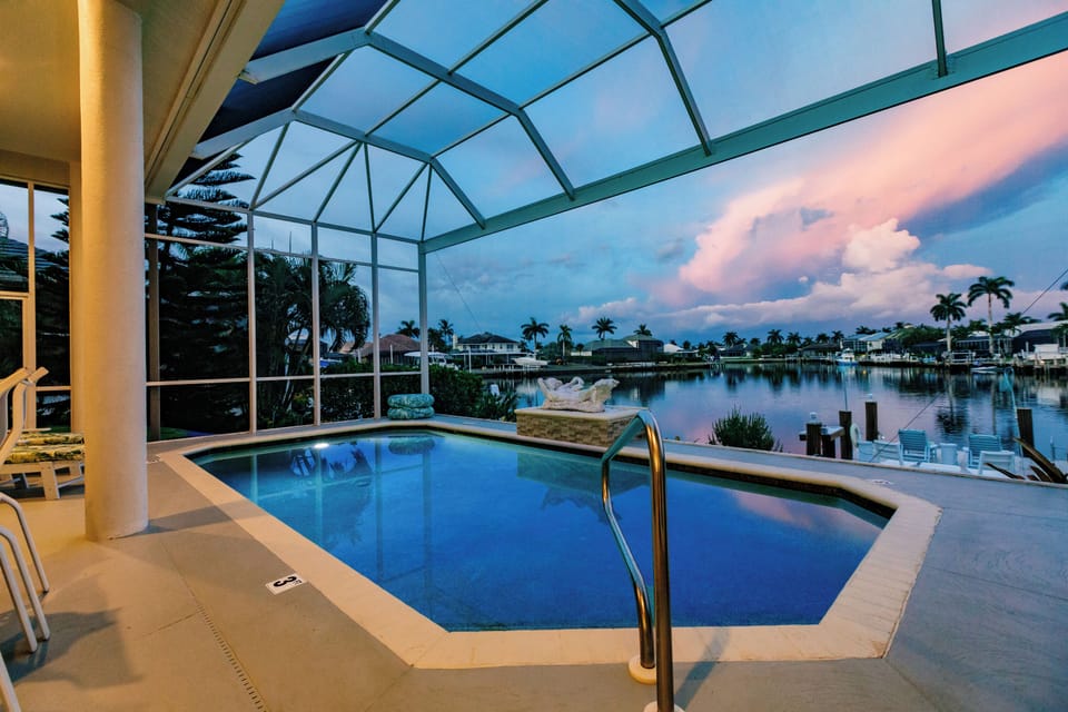 Poolside Paradise: Dive into luxury with stunning waterfront views and vibrant sunset hues!