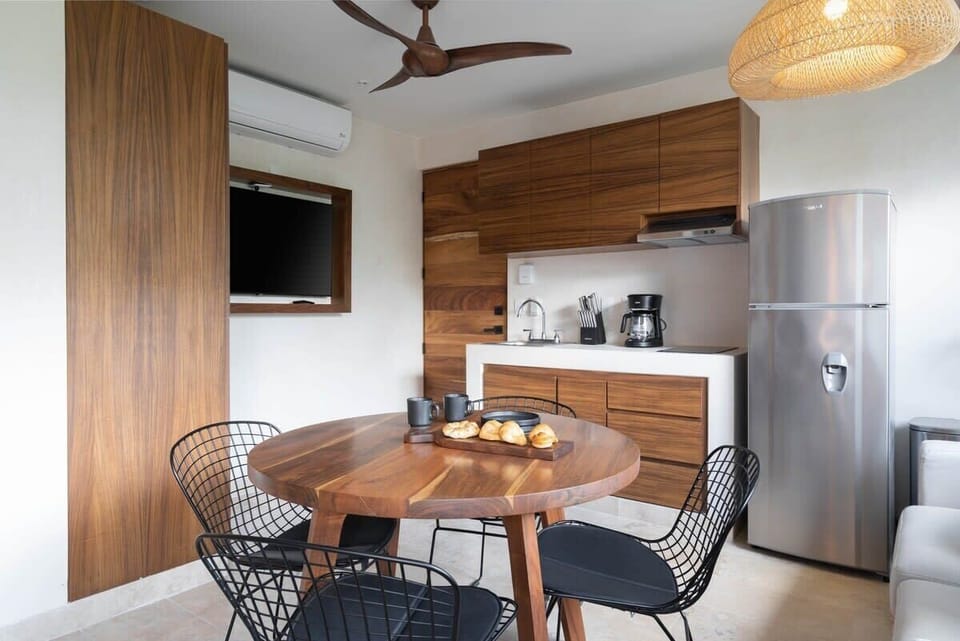 Complete kitchen and dining area in the bedroom.