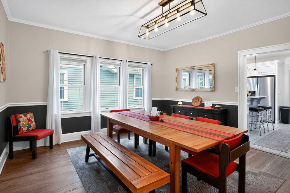 Dining Room-Check out the spacious and inviting dining room at The Cherry St House, complete with a large table perfect for hosting dinners, gatherings, or game nights. The vintage orange chairs add a touch of character to the room. Come and enjoy.