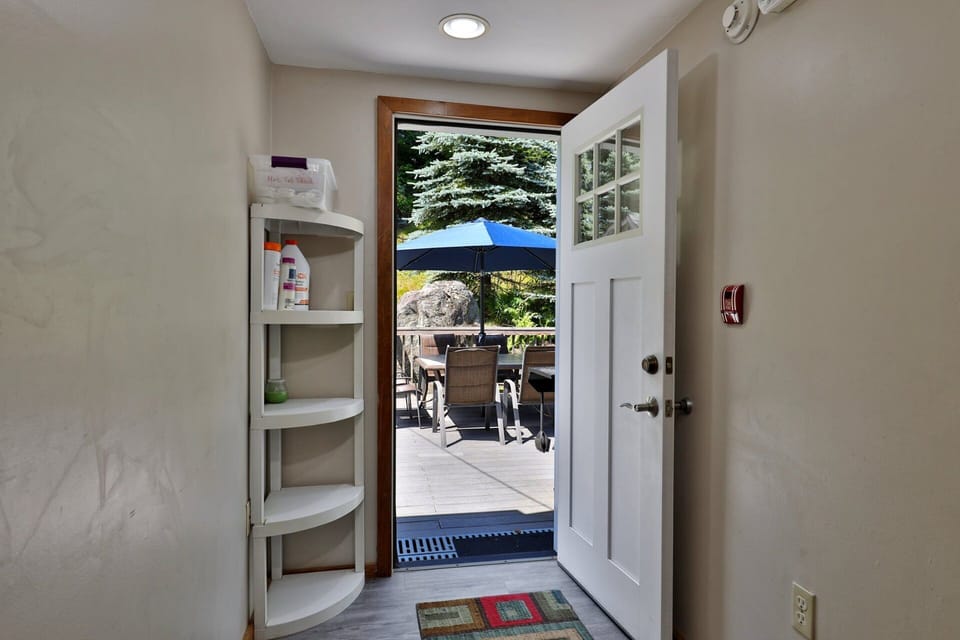 Open corner shelves by the deck door hold the smaller things you want to drop on the way inside.