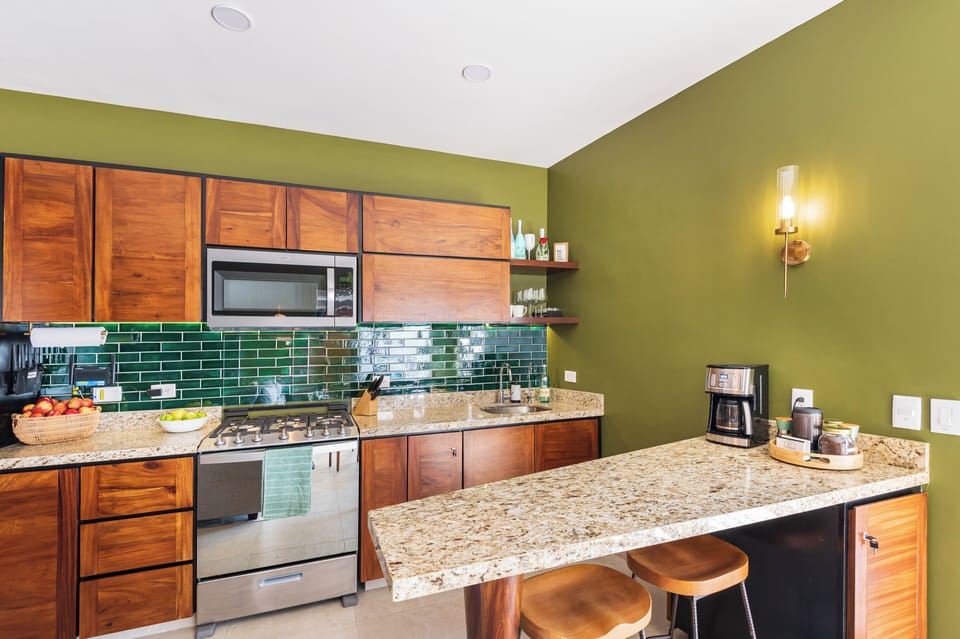 Fully equipped kitchen featuring a convenient coffee station.