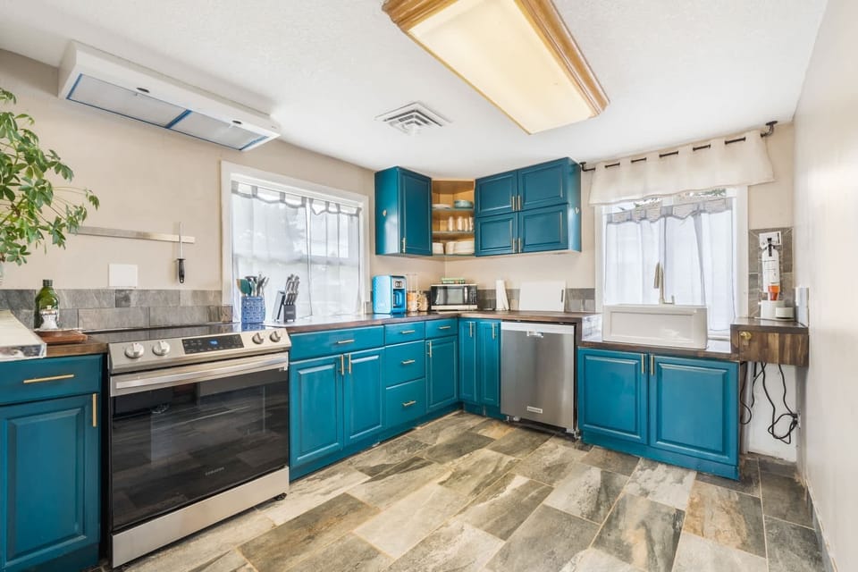Cook and gather in our charming kitchen space. Accented with a bohemian flair, it flows perfectly into the dining area and is fully prepared to handle all your vacation meal needs.