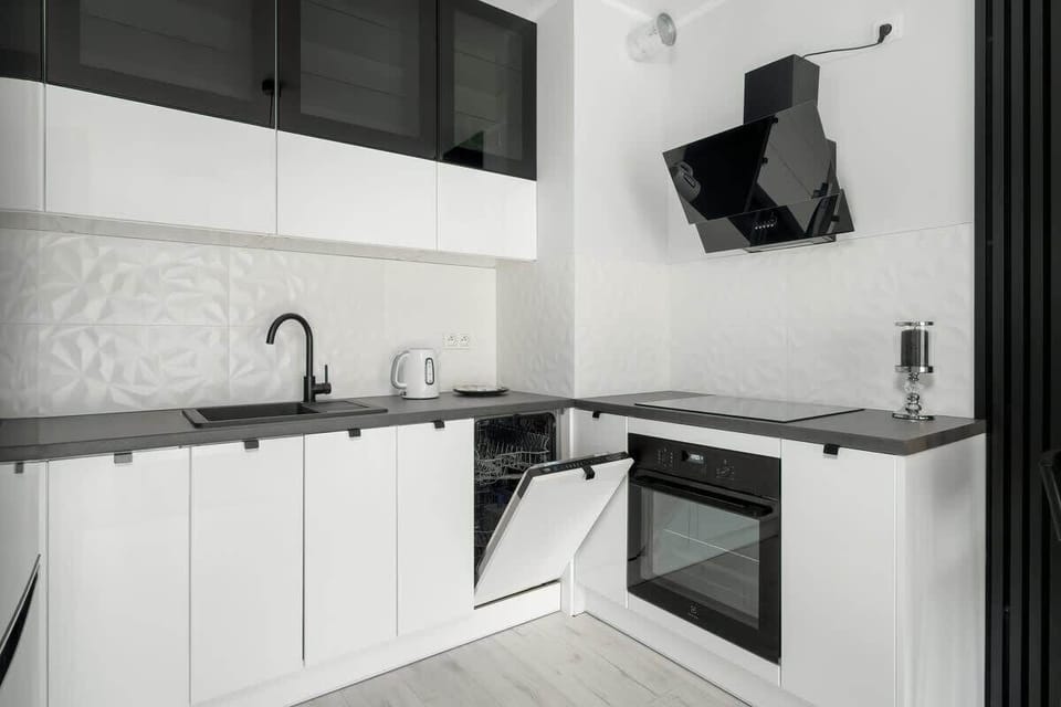 Kitchenette with oven and refrigerator. 