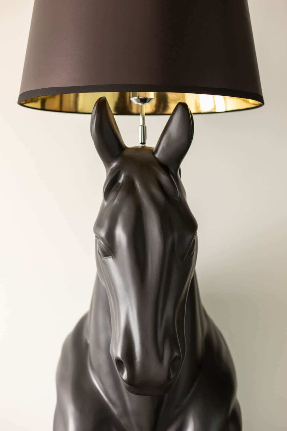 A close-up of a decorative black horse lamp. Stylish and quirky accent for the living space