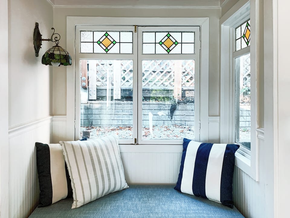 One of our favorite "nooks" the window seat is perfect for reading, a cup of tea, wine and catching up with friends.
