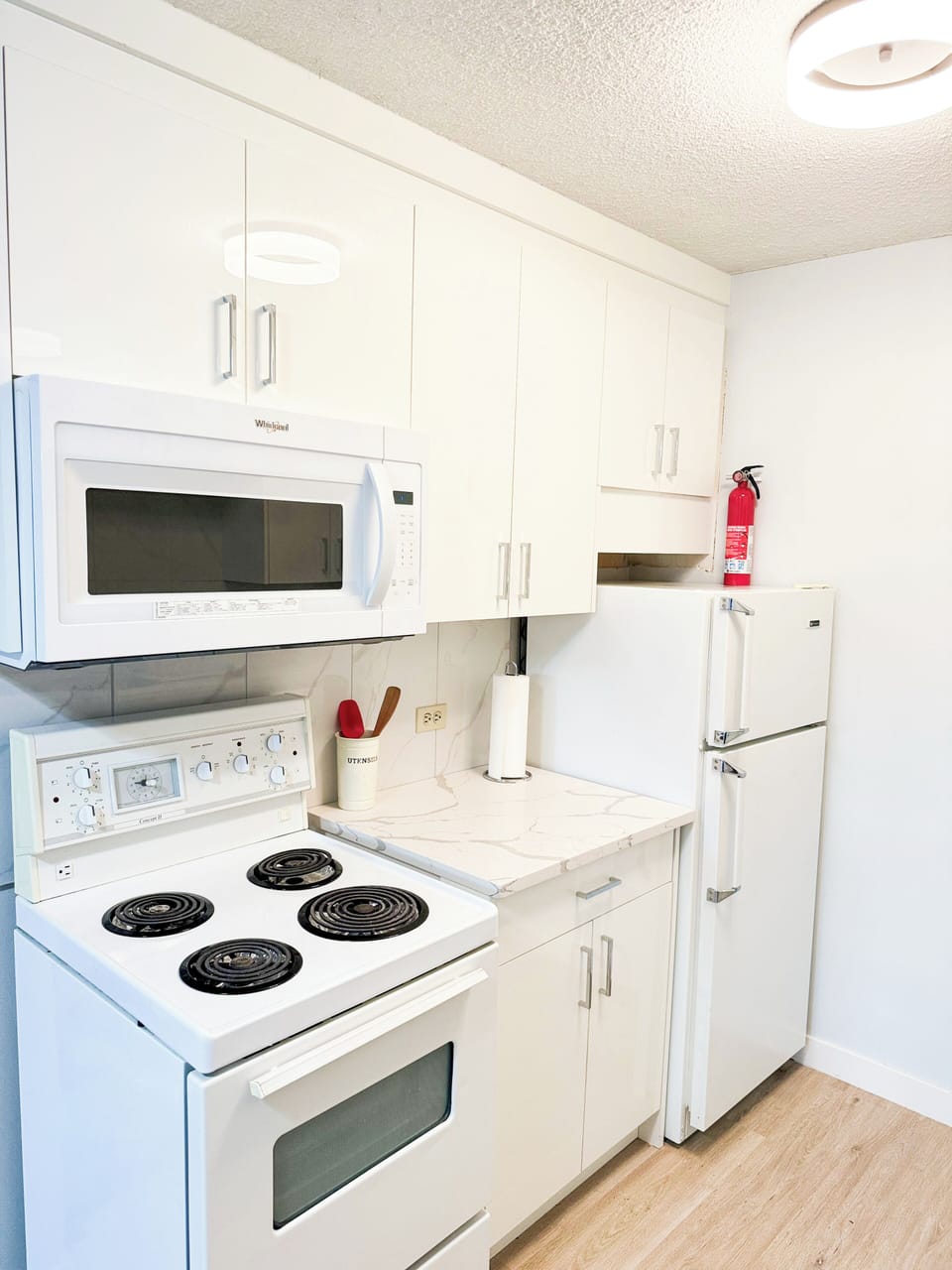 Well-appointed kitchen with a microwave, stove, and refrigerator.