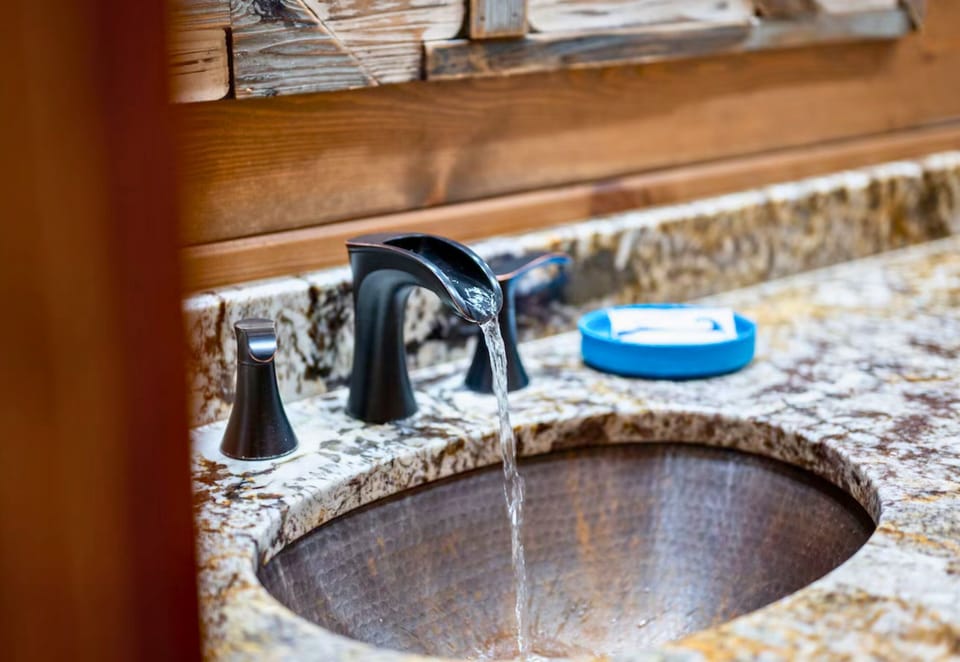 Modern amenities with a touch of rustic charm are evident in the bathroom's design.
