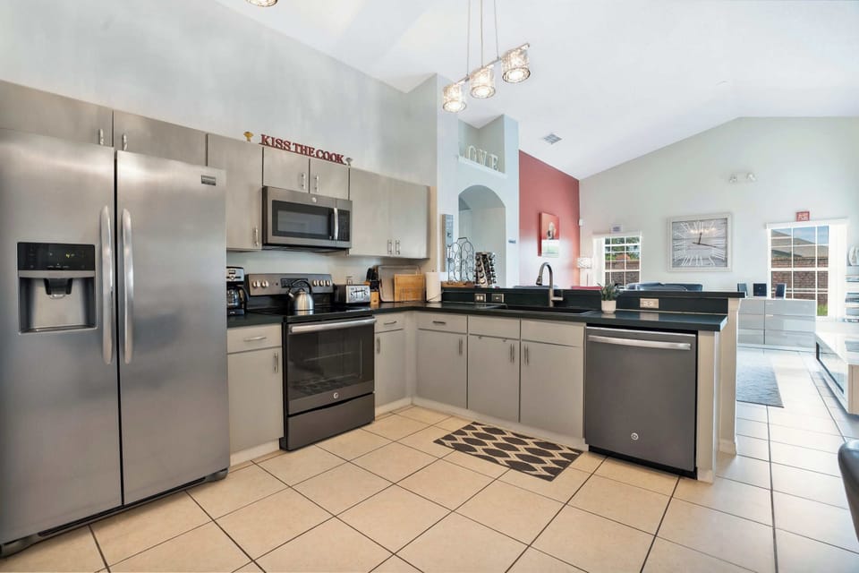Modern kitchen with stainless steel appliances and an open layout connecting to the living area.