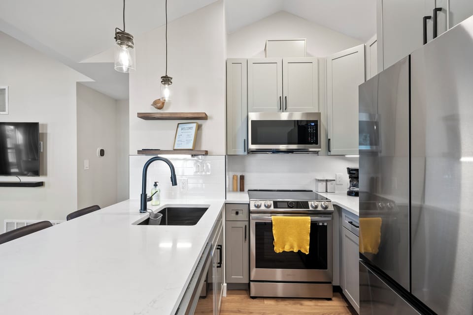 Stocked with high-end appliances including air fryer and induction stove. 