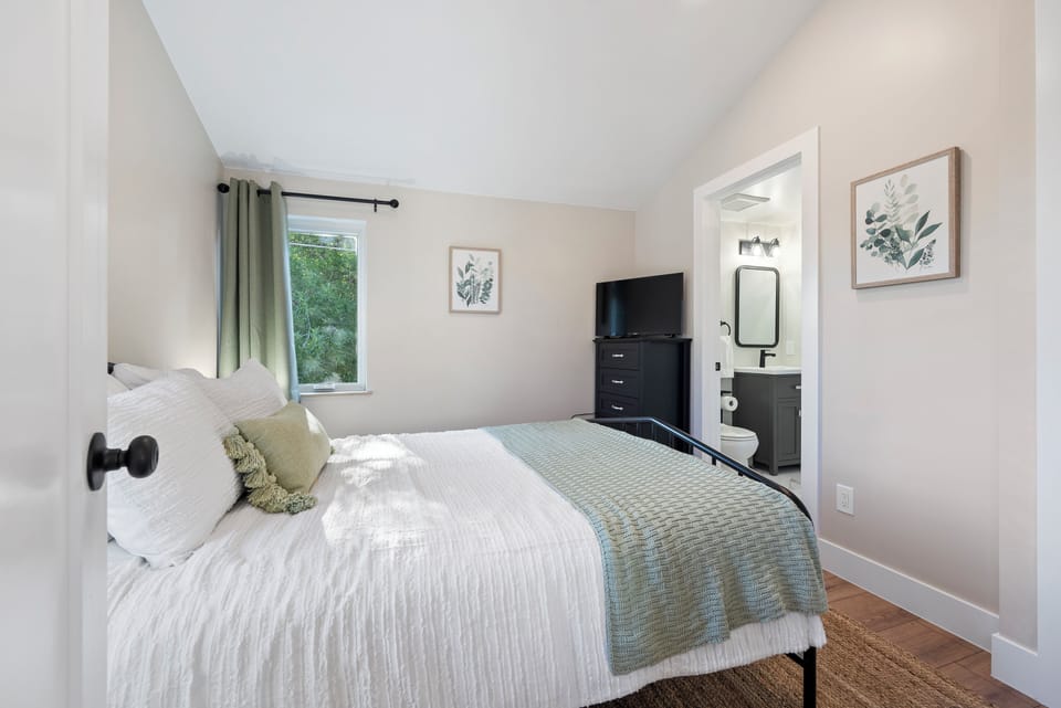Queen sized bed, luxury linens, black out curtains, TVs, and lots of storage