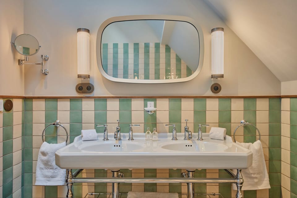 Suite Héloïse | Bathroom | Designer toiletries, hair dryer, slippers, towels