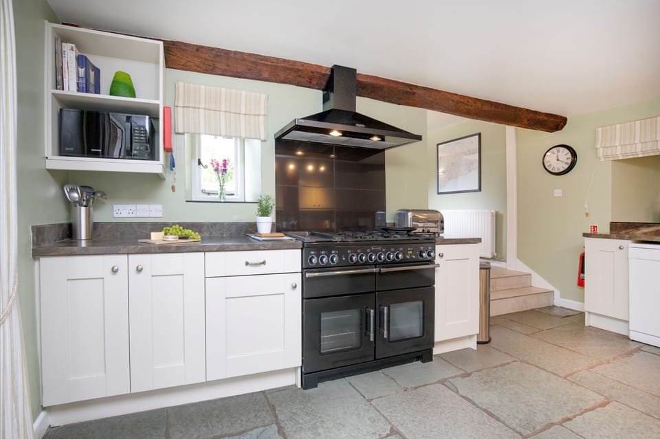 The kitchen with an electric range oven and gas hob