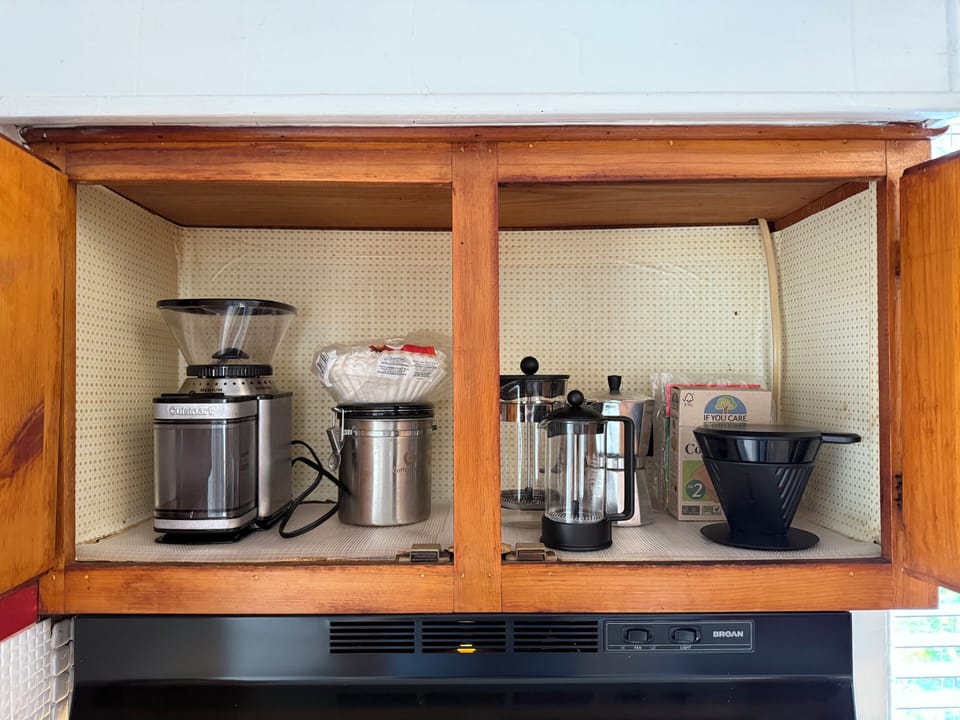 Extra coffee, making supplies in the cabinet