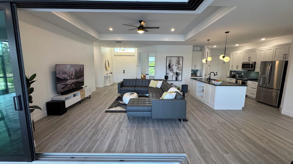 Living room with fully open sliding doors to lanai
