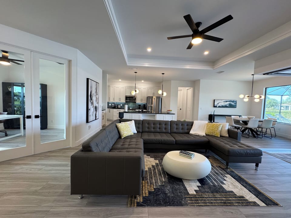 Living room with kitchen view - furniture and appliances are all brand new.