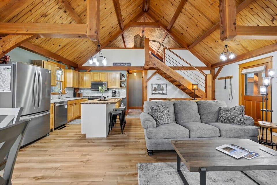 Experience chic living with a stunning living room featuring a stylish loft and an open kitchen, perfect for modern comfort and entertaining.