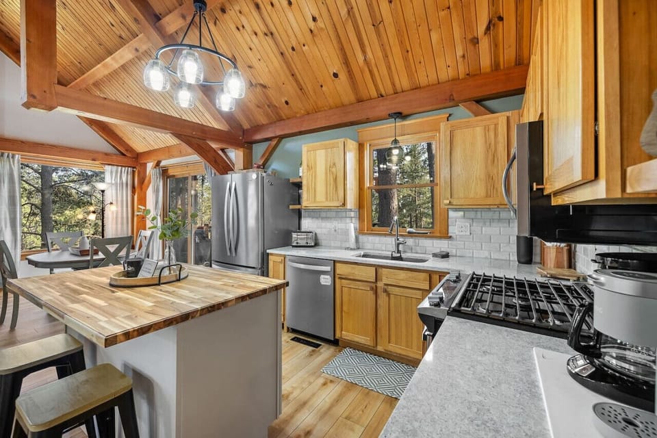 A fully stocked kitchen featuring a stove, dishwasher, refrigerator, and microwave for all your cooking and convenience needs.
