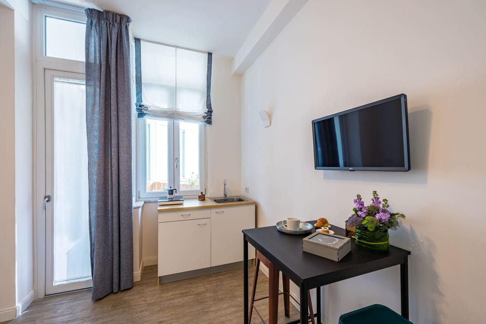 Triple Room, Balcony | Living area | TV