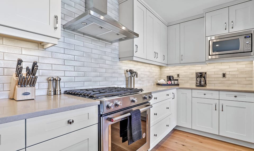 Fully stocked gourmet kitchen! High end stainless steel appliances and natural gas stove