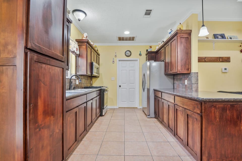 Kitchen leads into the laundry and office area.